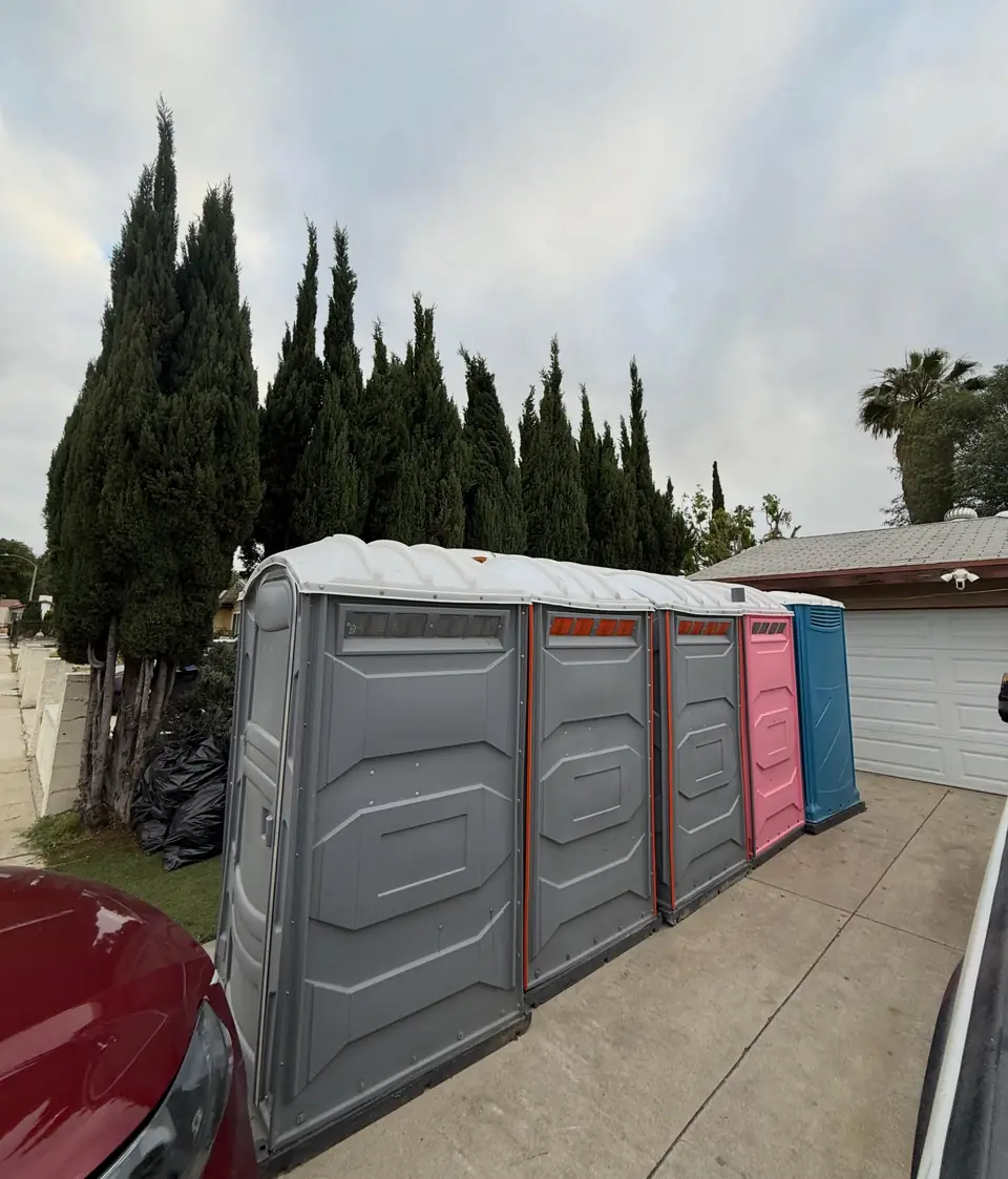 Row of porta potties strapped on a flatbed trailer for a job site route